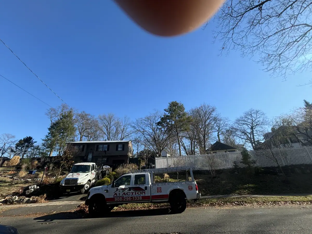 An A1 Action Contractors pickup and dump truck parked at a job on a residential street