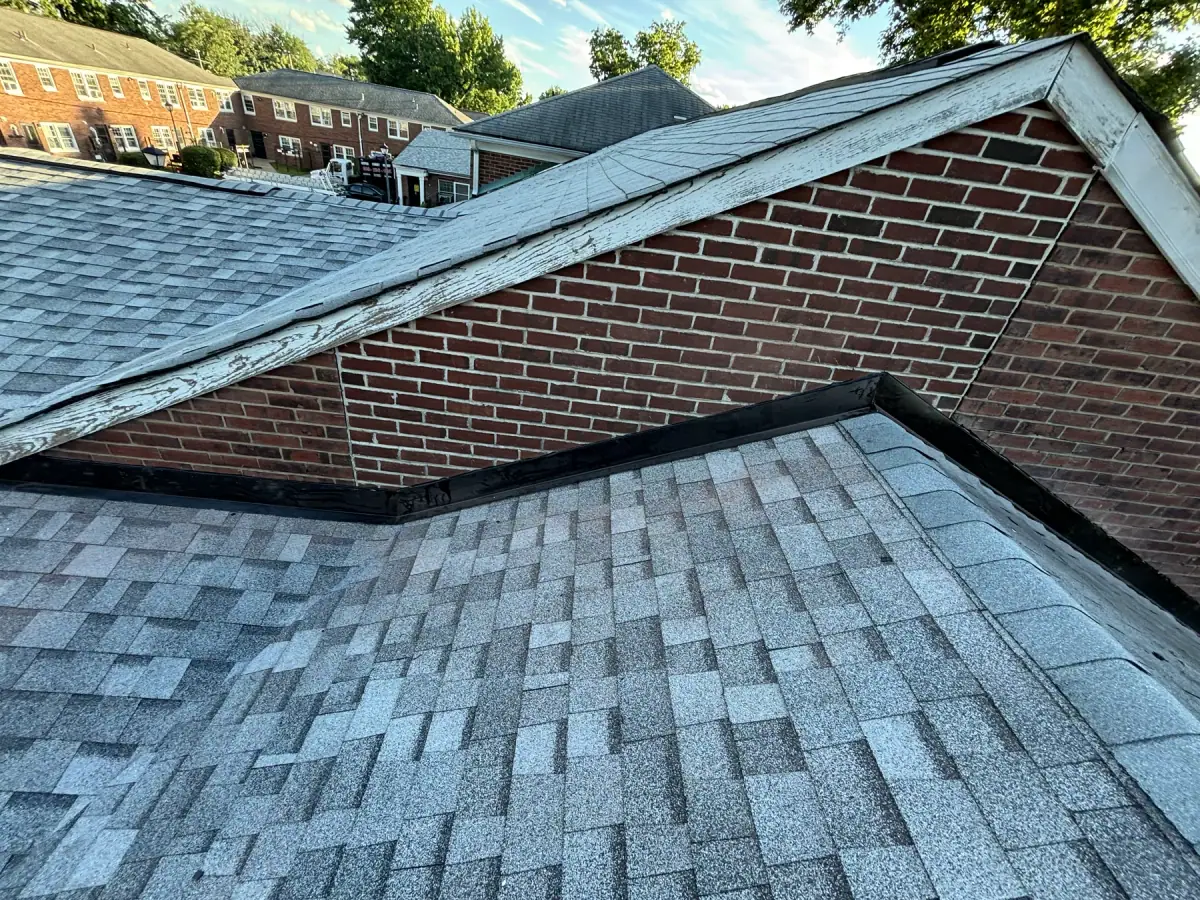 New shingles running into the brick wall of a neighbouring building, the valley finished
