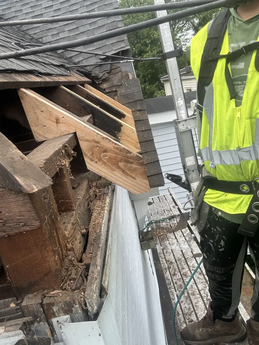 Rotted framing cut away at a roof edge, back to solid timber