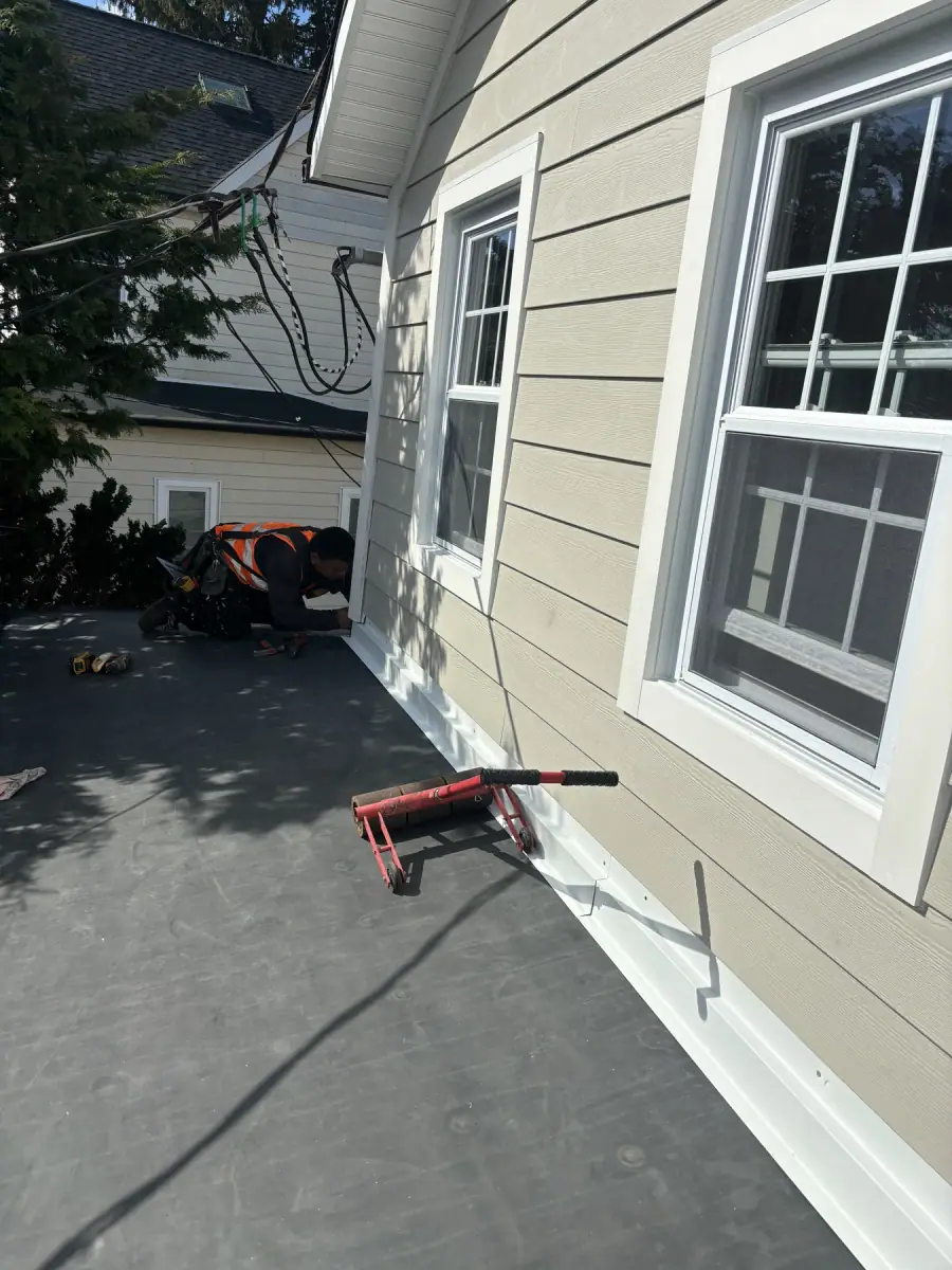 New light grey siding and white trim finished around a porch roof